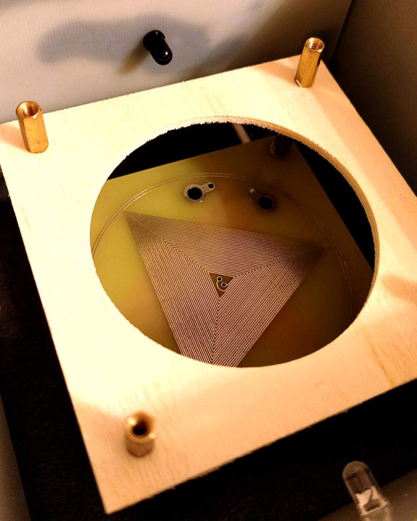 Core transmission element with precision engineered scalar coil generating structured resonance field